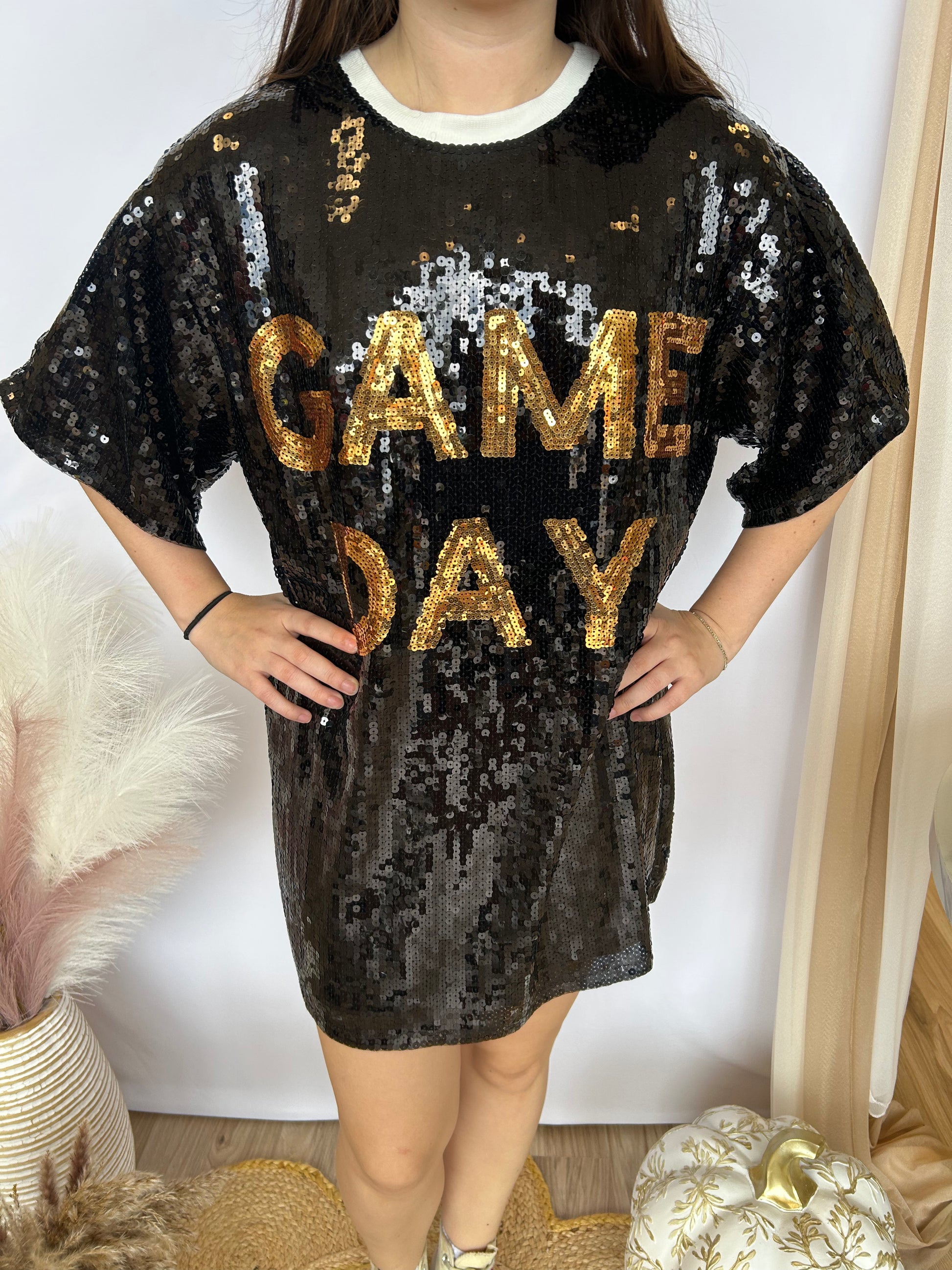 Black sequin dress with 'GAME DAY' text worn by a person indoors.