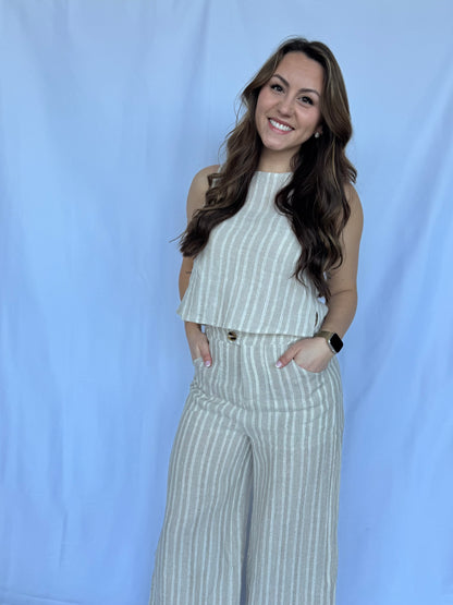 Woman wearing a striped outfit against a light blue background