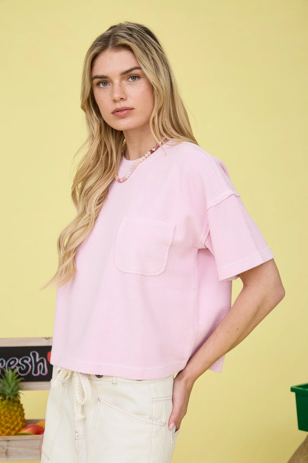 Woman wearing a pink shirt with a yellow background