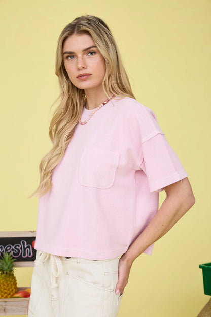 Woman wearing a pink shirt with a yellow background