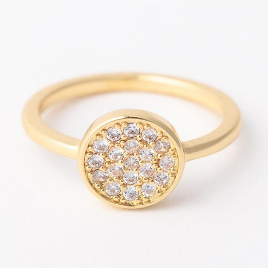 Gold ring with diamond-studded center on a white background