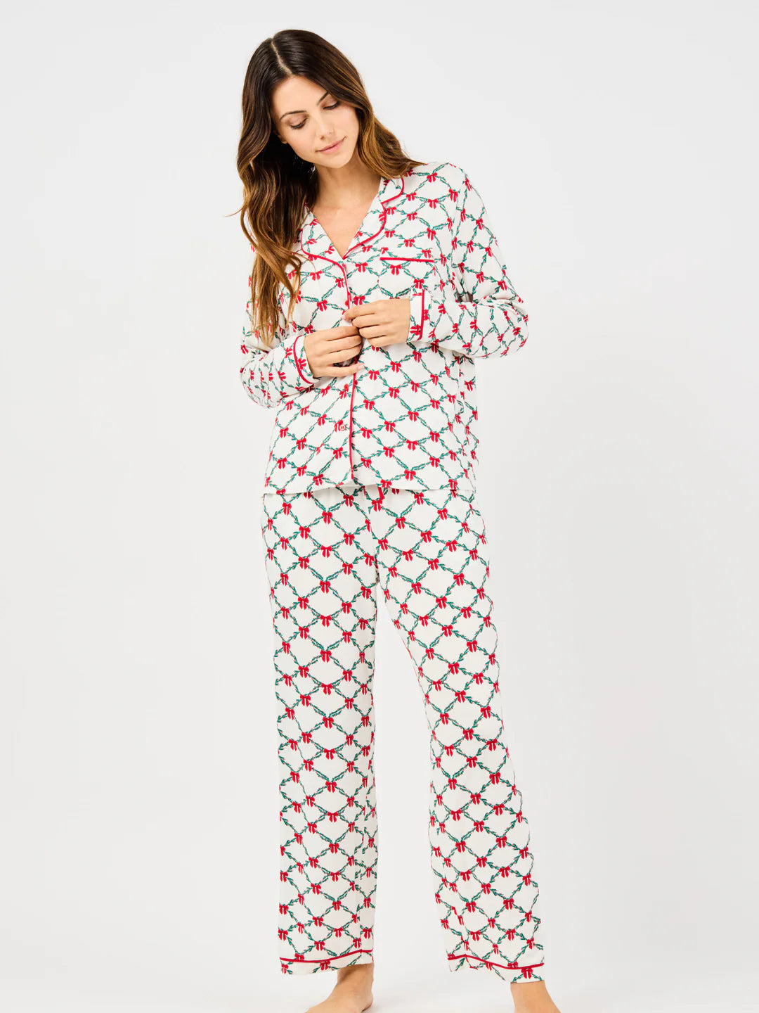 Woman wearing a patterned pajama set on a white background