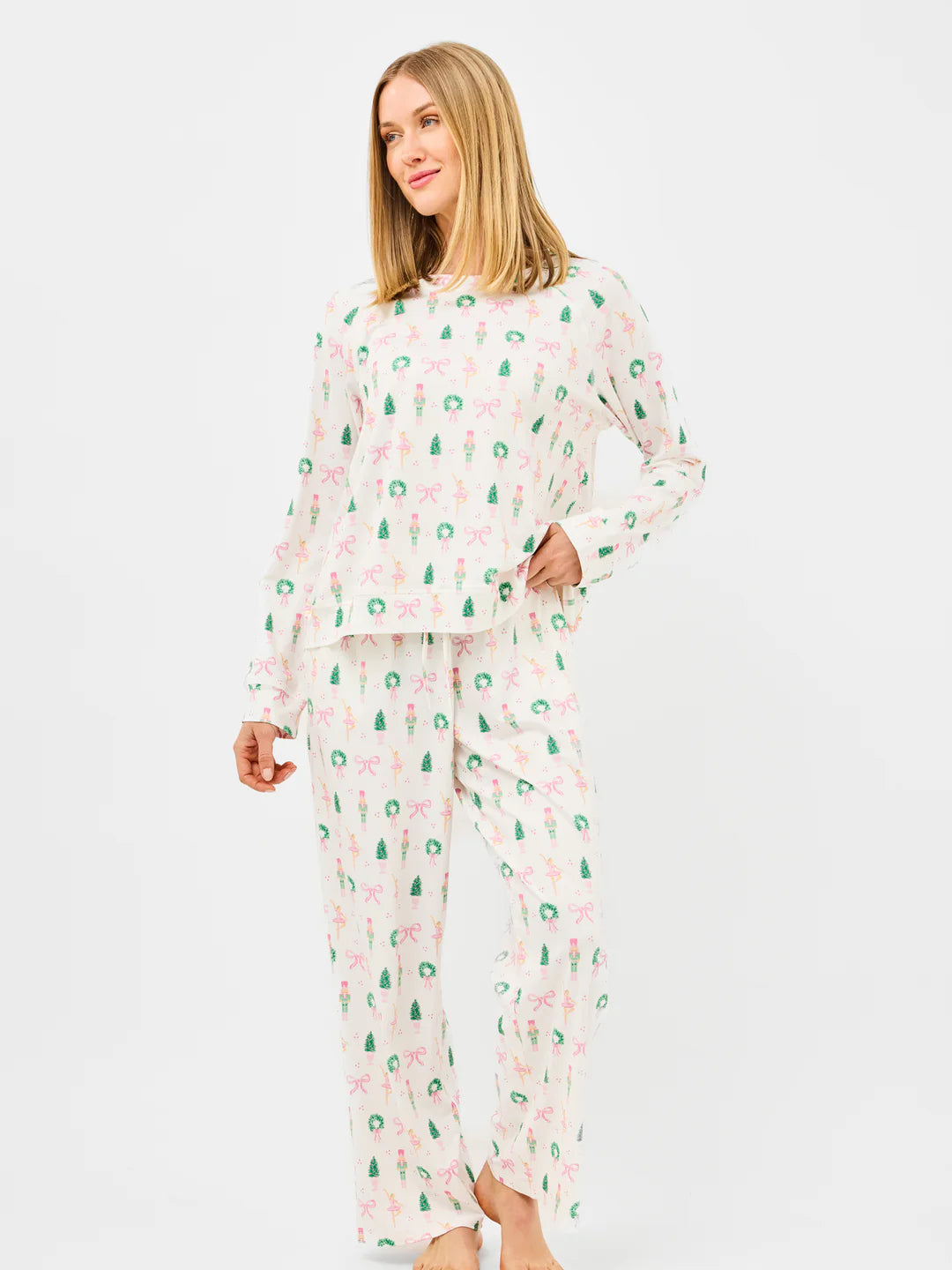Woman wearing a pajama set with a pattern on a white background