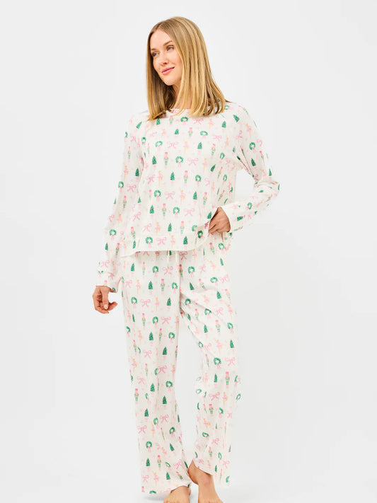Woman wearing a pajama set with a pattern on a white background